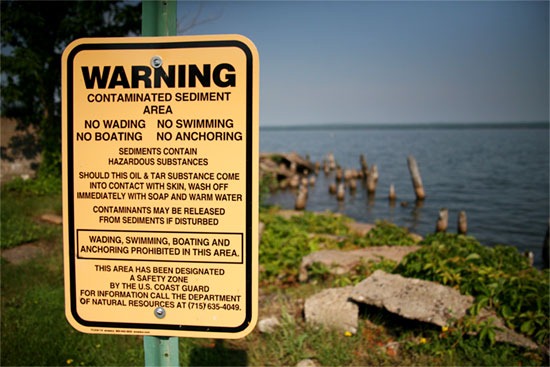 A sign along Ashland’s downtown waterfront warns of the hazardous coal tar that has contaminated sediments in the area.
