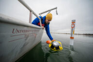 Craig Hill places the Spotter Buoy into Lake Superior near Park Point Beach in Duluth, MN.