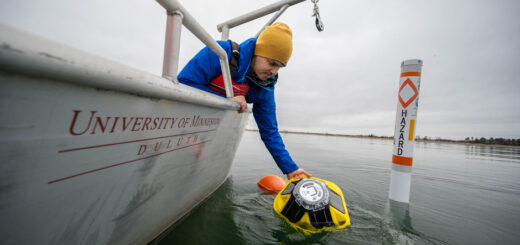 Craig Hill places the Spotter Buoy into Lake Superior near Park Point Beach in Duluth, MN.